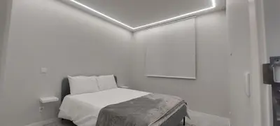 a bedroom with a bed in a white room at Seven in Funchal