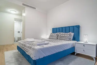 a blue bed with a blue headboard in a bedroom at The PLACE in Funchal