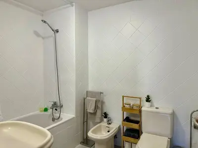 a white bathroom with a toilet and a sink at SUPER Anadia - Turquesa in Funchal