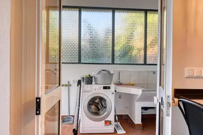 a washing machine in a bathroom with a sink at Freitas Paradise, a Home in Madeira in Ponta do Sol