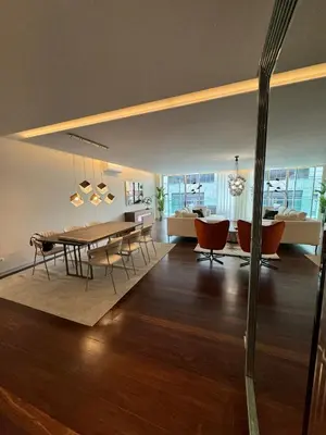 a dining room and living room with a table and chairs at Funchal Next Corner Plaza in Funchal