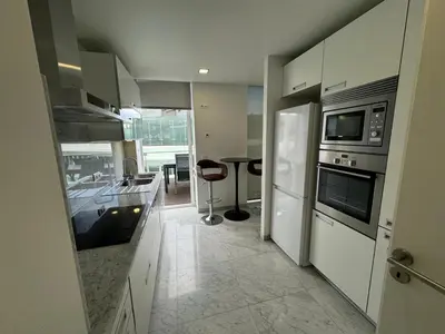 a kitchen with white cabinets and a stove top oven at Funchal Next Corner Plaza in Funchal