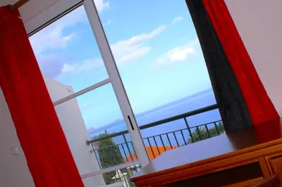 a view of the ocean from a window at Moradia Bela House in Santa Cruz