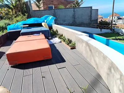 a small bedroom with a bed and a door at Casa Carreira in Ponta do Sol