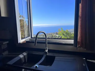 a kitchen sink with a view of the ocean at Lucky Lemons - Boutique Houses Madeira - 2 in Estreito da Calheta