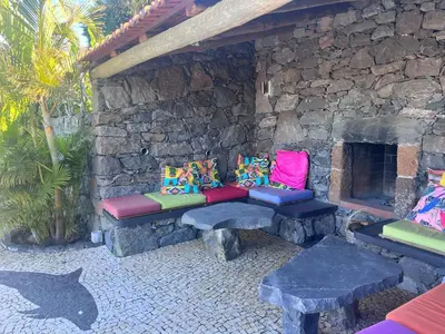 a stone wall with a bench and a stone fireplace at Lucky Lemons - Boutique Houses Madeira - 2 in Estreito da Calheta