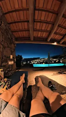 a couple of people laying on a couch with their feet up at Lucky Lemons - Boutique Houses Madeira - 2 in Estreito da Calheta