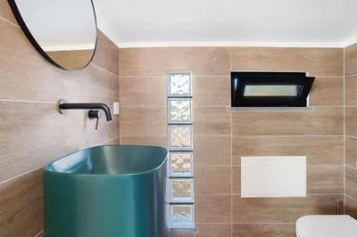a white bedroom with a bed and a staircase at Casa Do Lenhador in Canhas