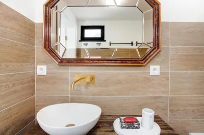 a bathroom with a toilet and a green bath tub at Casa Do Lenhador in Canhas