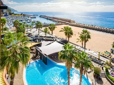 an aerial view of a resort with a pool and a beach at Sunny Rooftop & perfect view in Arco da Calheta
