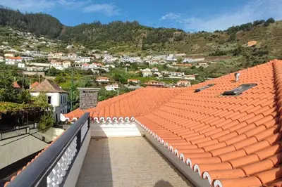 an orange roof with a view of a town at Sunny Rooftop & perfect view in Arco da Calheta