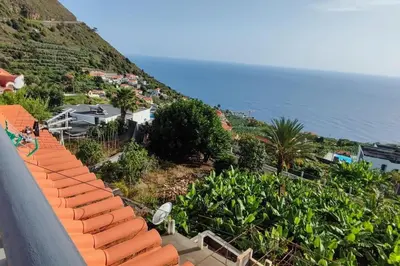 an aerial view of a resort with the ocean at Sunny Rooftop & perfect view in Arco da Calheta
