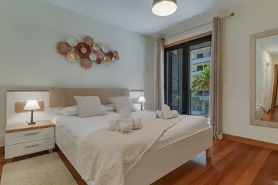 a bedroom with a large white bed and a window at Lido Charm by Atlantic Holiday in Funchal