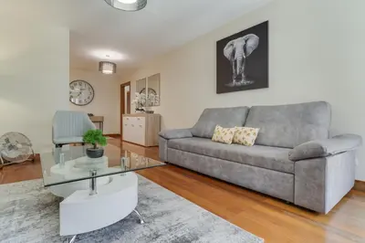 a living room with a couch and a glass table at Lido Charm by Atlantic Holiday in Funchal