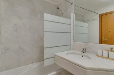 a white bathroom with a sink and a mirror at Lido Charm by Atlantic Holiday in Funchal
