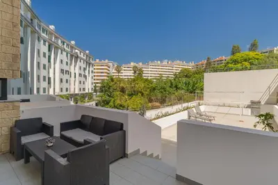 a balcony with furniture and a view of buildings at Lido Charm by Atlantic Holiday in Funchal