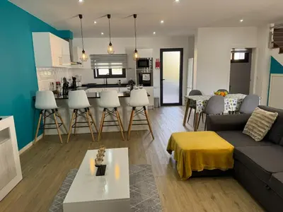 a living room and kitchen with a couch and a table at E - Elegant Terraced Home with FREE Private Parking in Machico