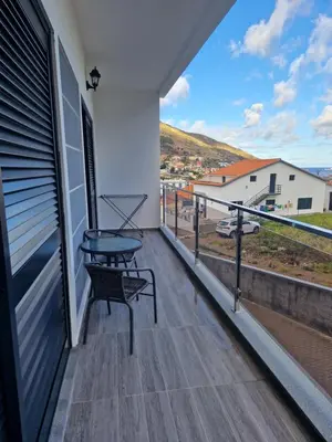 a balcony with a table and a view at E - Elegant Terraced Home with FREE Private Parking in Machico
