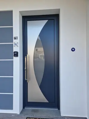 a blue door with a large window on a building at E - Elegant Terraced Home with FREE Private Parking in Machico