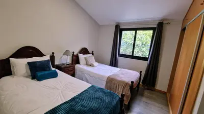 a small bedroom with two beds and a window at Madeira Mountain Paradise - Casa da Levada do Arco in Arco da Calheta