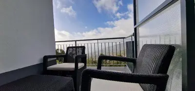 two chairs sitting on a balcony with a view at Madeira Mountain Paradise - Casa da Levada do Arco in Arco da Calheta