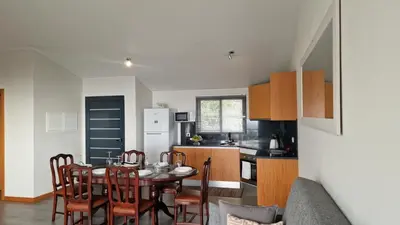 a kitchen and dining room with a table and chairs at Madeira Mountain Paradise - Casa da Levada do Arco in Arco da Calheta
