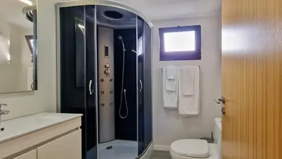 a bathroom with a shower with a toilet and a sink at Madeira Mountain Paradise - Casa da Levada do Arco in Arco da Calheta