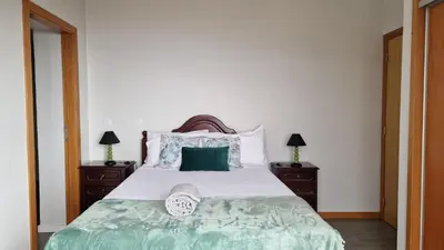 a bedroom with a large bed with two night stands at Madeira Mountain Paradise - Casa da Levada do Arco in Arco da Calheta