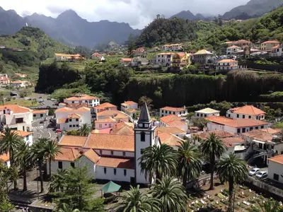 a town with a clock tower and palm trees at Holidays Madeira in São Vicente
