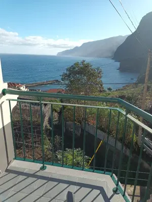 a balcony with a view of the ocean at Sunrise Bay - Modern Flat with stunning views in Seixal