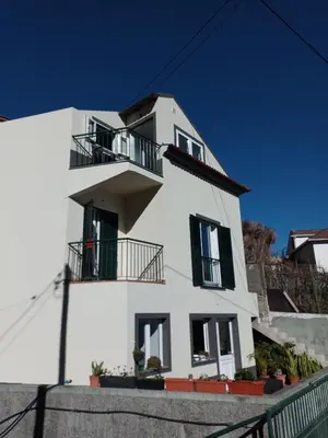 a white house with black windows and a balcony at Sunrise Bay - Modern Flat with stunning views in Seixal
