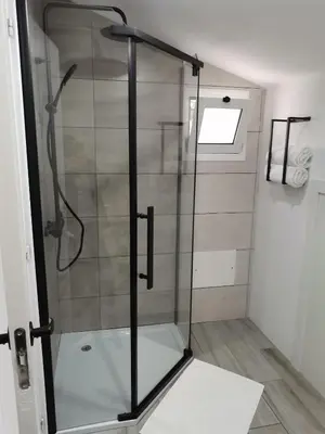 a shower with a glass door in a bathroom at Sunrise Bay - Modern Flat with stunning views in Seixal
