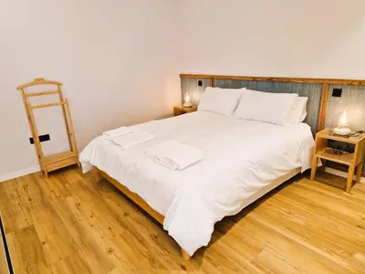 a bedroom with a bed with white sheets and a ladder at SHELL LIVING - Infinity Loft in Funchal