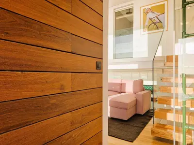 a pivot door in a living room with a pink couch at SHELL LIVING - Infinity Loft in Funchal