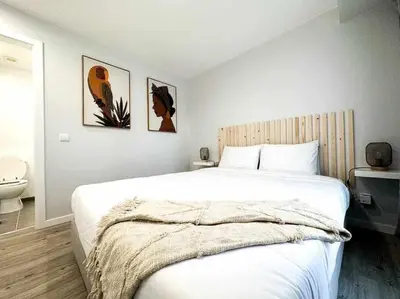 a bedroom with a large white bed and a bathroom at Pena Apartments - A by MTH in Funchal