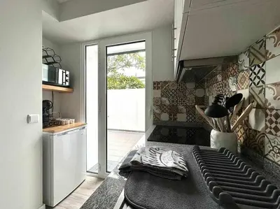 a room with a kitchen with a counter and a table at Pena Apartments - A by MTH in Funchal