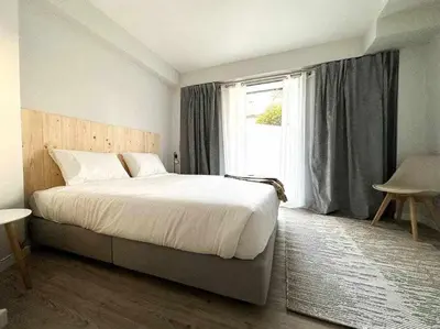 a bedroom with a large bed and a window at Pena Apartments - A by MTH in Funchal