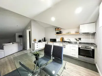a kitchen with white cabinets and chairs in a room at Pena Apartments - C by Mth in Funchal