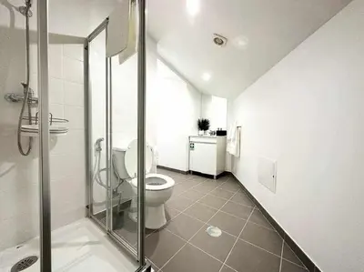 a bathroom with a toilet and a glass shower at Pena Apartments - C by Mth in Funchal