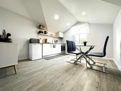 a kitchen with a table and chairs in a room at Pena Apartments - C by Mth in Funchal