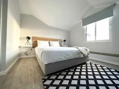 a bedroom with a large bed and a window at Pena Apartments - C by Mth in Funchal