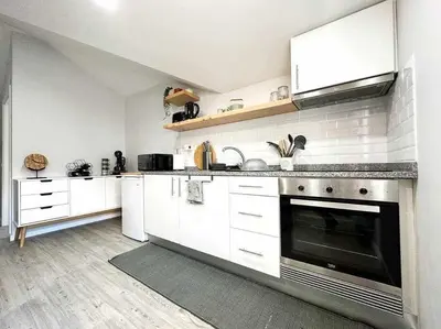 a kitchen with white cabinets and a stove top oven at Pena Apartments - C by Mth in Funchal