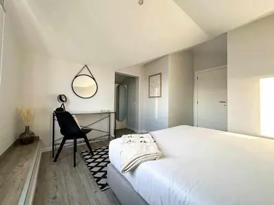 a bedroom with a bed and a desk and a chair at Pena Apartments - C by Mth in Funchal
