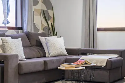 a living room with a couch and a table at White Rabbit II by Homie in Calheta