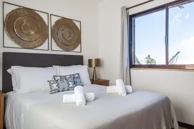 a bedroom with two beds with white sheets and a window at White Rabbit II by Homie in Calheta