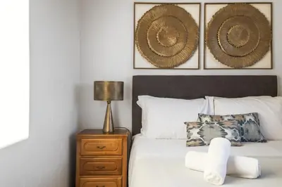 a bedroom with a bed and a lamp on a night stand at White Rabbit II by Homie in Calheta