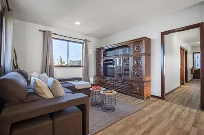 a living room with a couch and a large entertainment center at White Rabbit II by Homie in Calheta