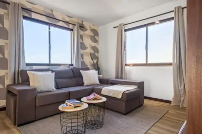 a living room with a couch and two windows at White Rabbit II by Homie in Calheta