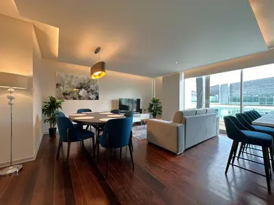 a living room with a table and chairs and a couch at Luxury Apartment in the Center in Funchal