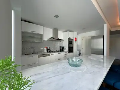 a kitchen with white cabinets and a bowl on a counter at Luxury Apartment in the Center in Funchal